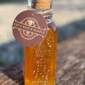 A bottle of honey sitting on top of a table.